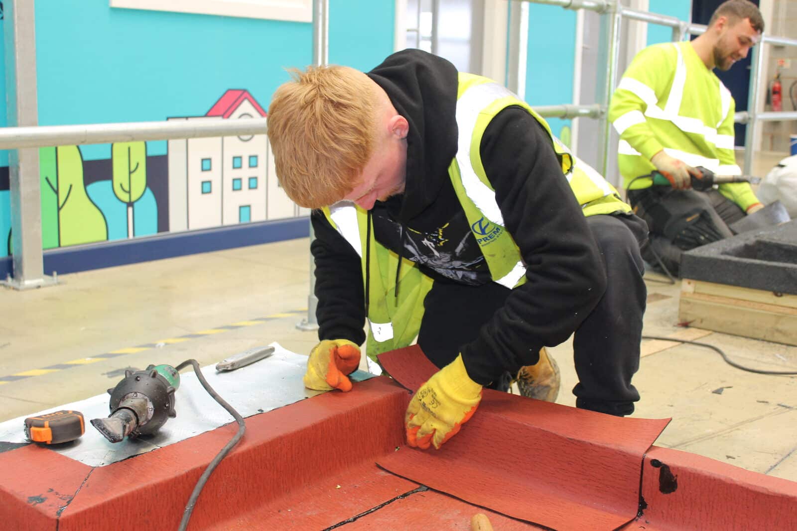 Roofing apprentice practising a heat-welded detail at the training centre
